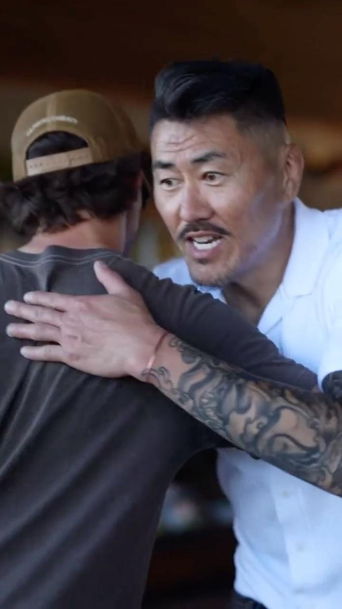 June An hugging a member at a Friday gathering