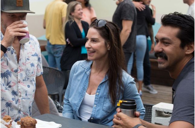 Members talking over coffee on a patio